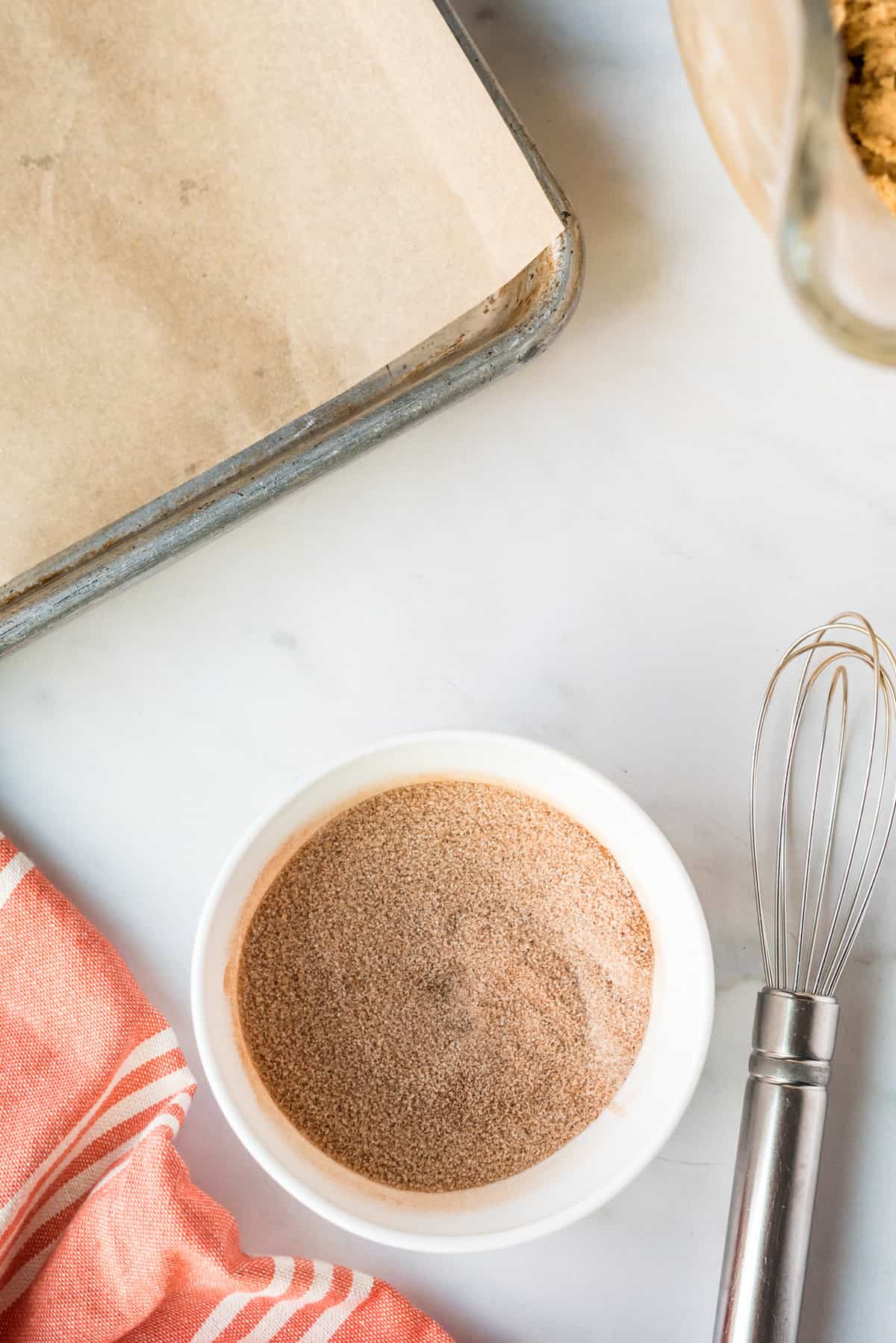 Cinnamon and sugar in white bowl mixed together