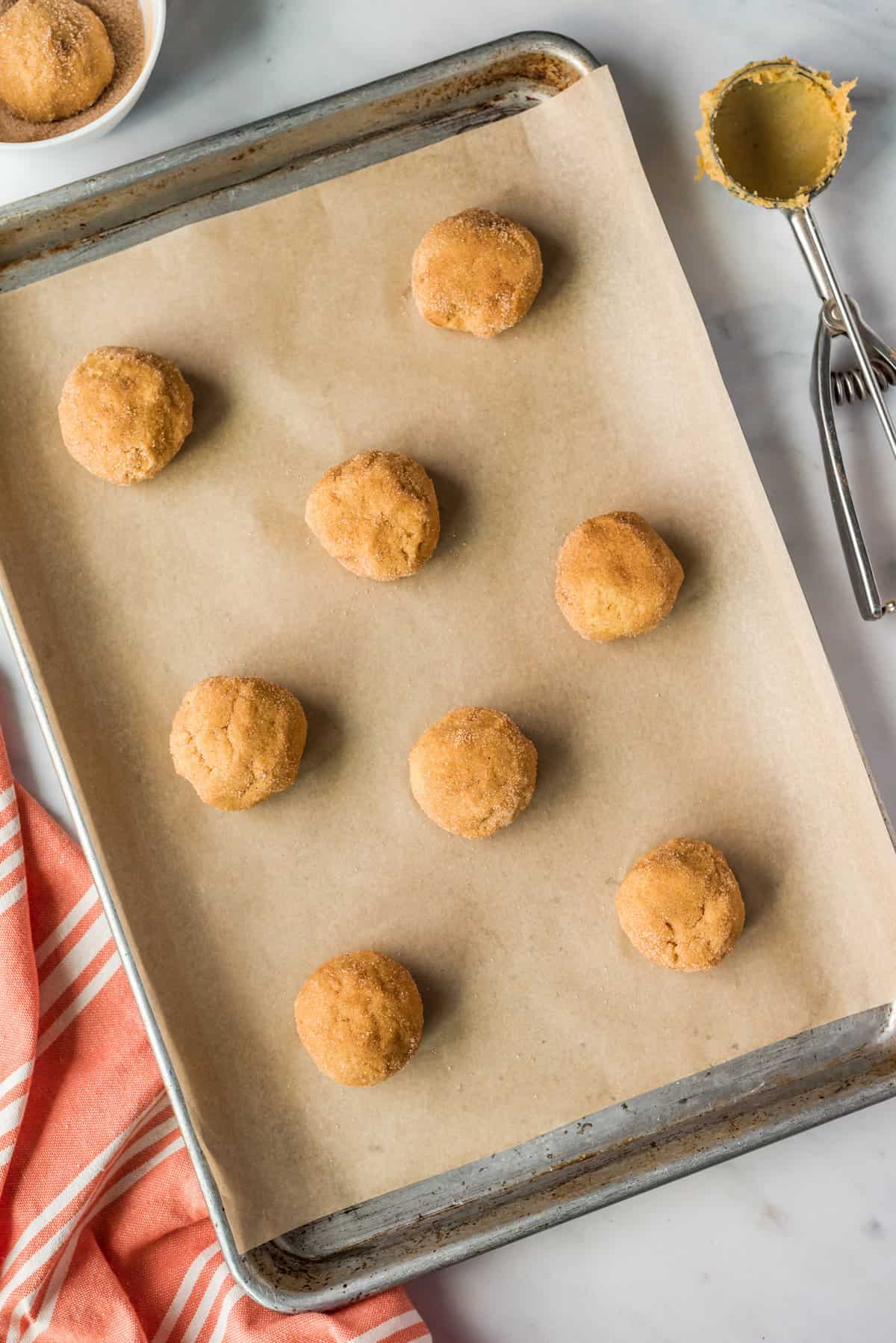 Pumpkin Snickerdoodle dough balls on baking sheet