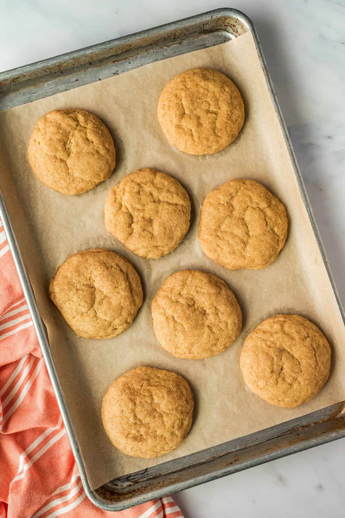 Pumpkin Snickerdoodle cookies on baking sheet after baking.