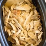 Overhead image of make ahead crock pot turkey in a black crock pot