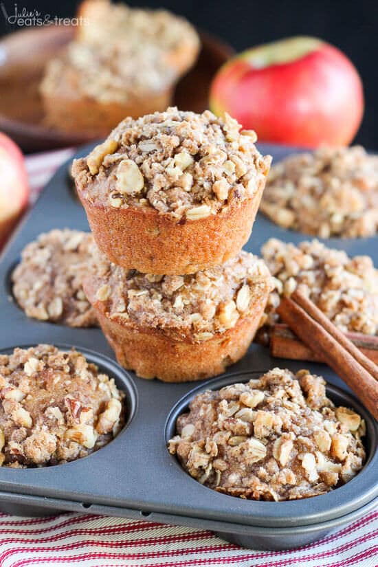 Apple Muffins Recipes stacked on muffin tin sitting on red striped napkin.