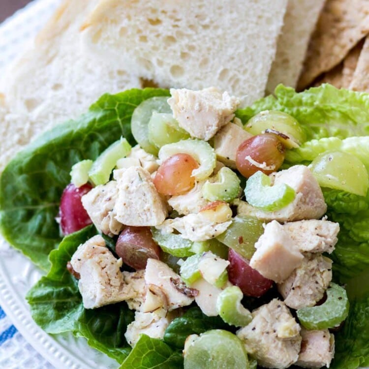Chicken salad on a plate along with slices of bread
