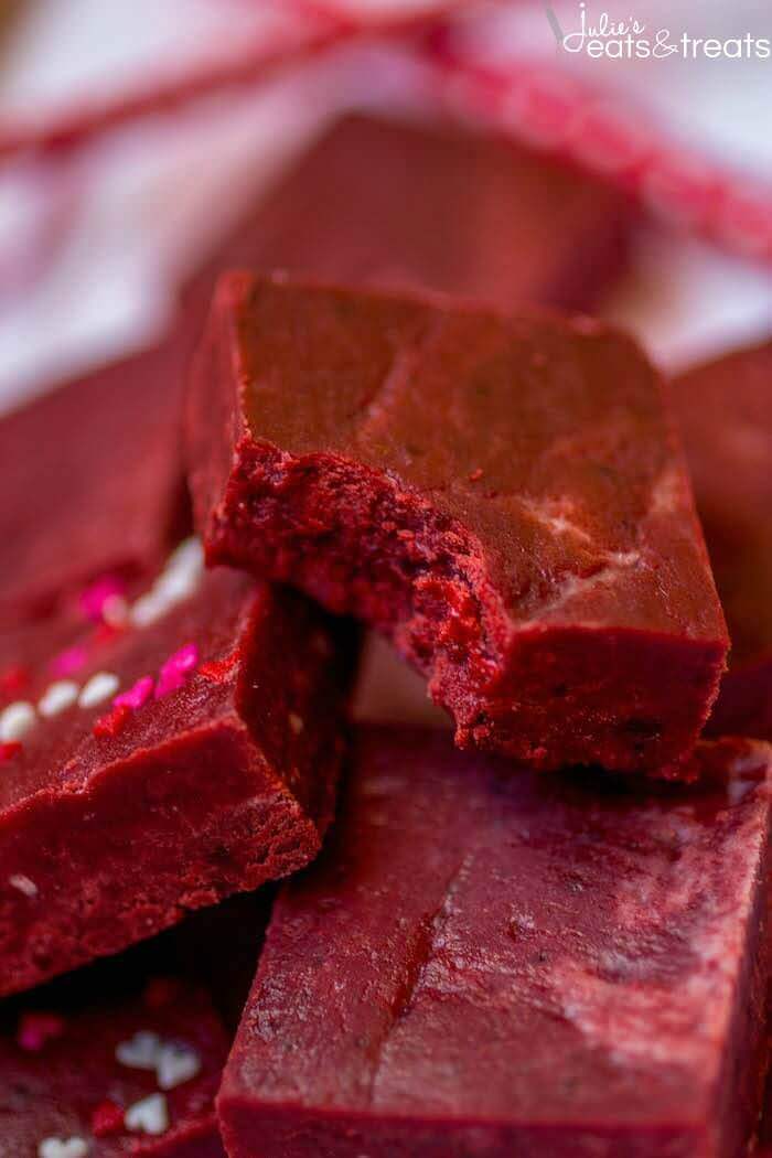 Red Velvet Fudge in a stack with one piece has a bite taken out of it