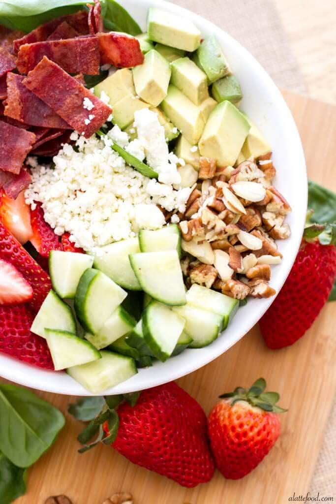 This easy salad is packed with the works: strawberries, avocado, turkey bacon, feta cheese, pecans, almonds and cucumbers over a bed of spinach. Top with your favorite dressing for the ultimate healthy meal. 