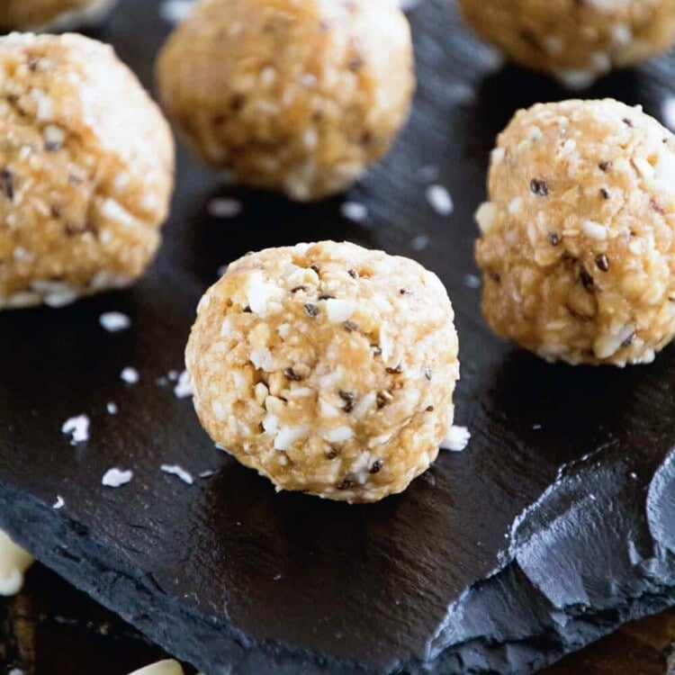 White chocolate macadamia nut energy balls on a slate tray