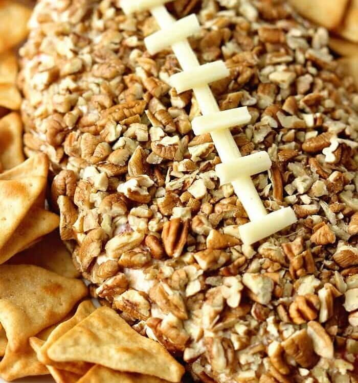 A football cheeseball surrounded by pita chips