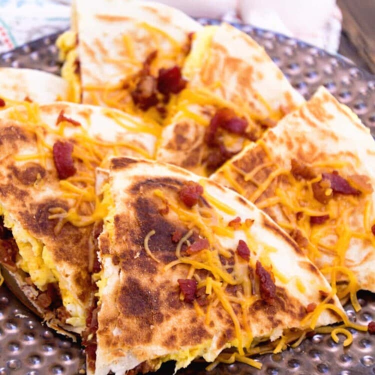 Bacon egg and cheese quesadilla slices on a plate