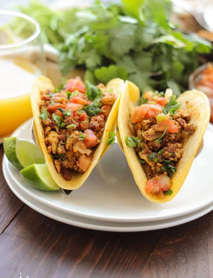 Chorizo Breakfast Tacos ~ Soft scrambled eggs mixed with chorizo and vegetables, then stuffed into a corn tortilla with beans. Topped with some salsa, pico de gallo and cheese. This is a breakfast dish you won't want to miss!