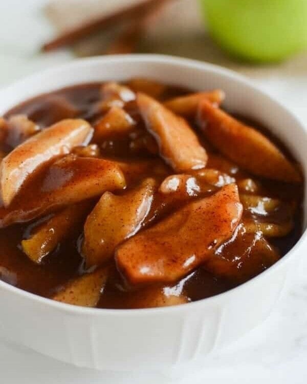 White bowl of crock pot cinnamon apples