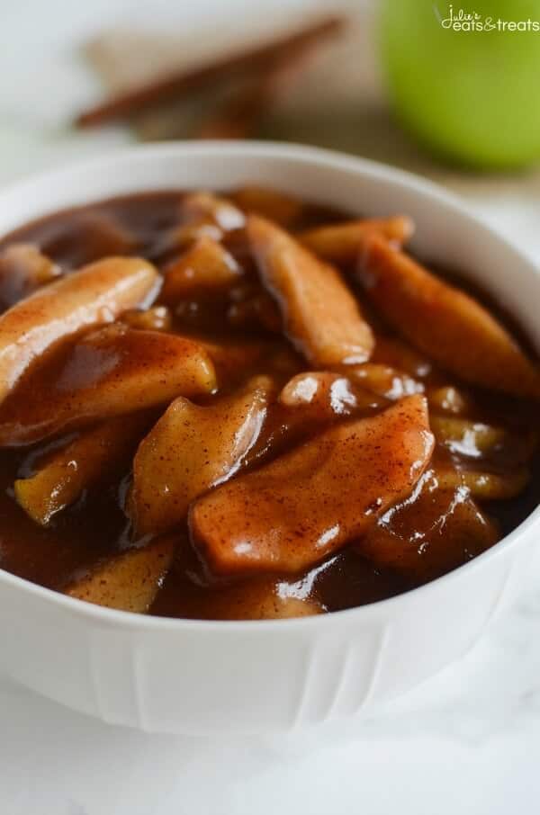 Crock Pot Cinnamon Apples - easy and delicious spiced apples! Perfect served with ice cream, on pancakes, or eaten with a spoon!