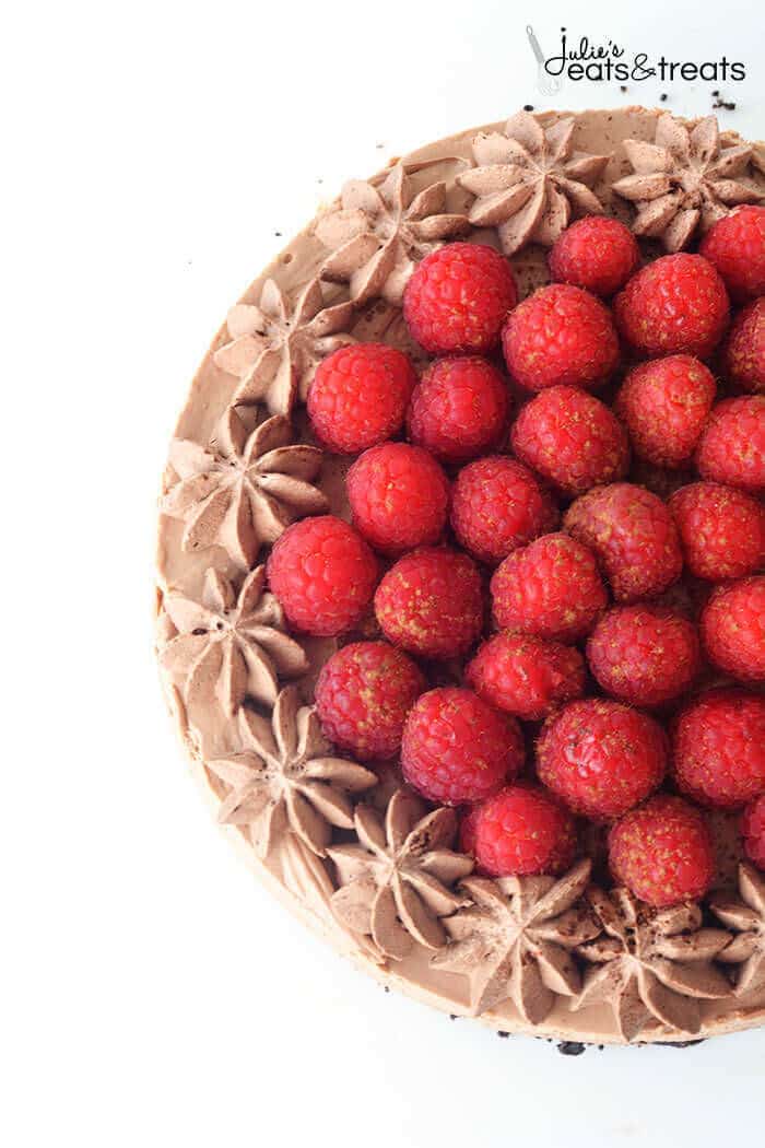 A No Bake Chocolate Cheesecake and Topped with Fresh Raspberries and Chocolate Whipped Cream!