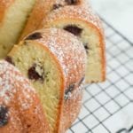 Slices of a bundt shaped blueberry sour cream pound cake on a cooling rack