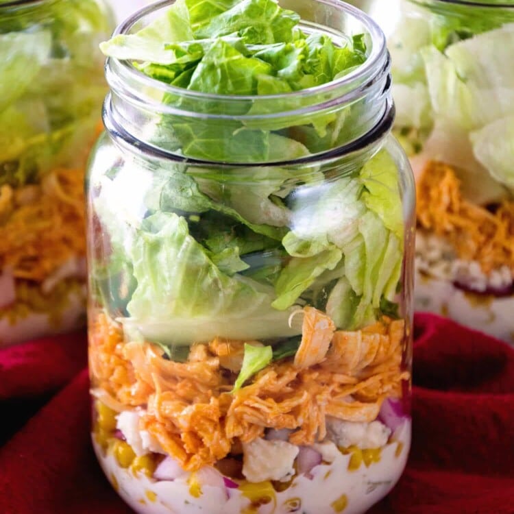 Buffalo Chicken Jar Salad ~ Easy, Light and Healthy Lunch Full of Flavor! Layers of Blue Cheese Dressing, Celery, Blue Cheese Crumbles, Corn, Onions, Buffalo Chicken and Lettuce!