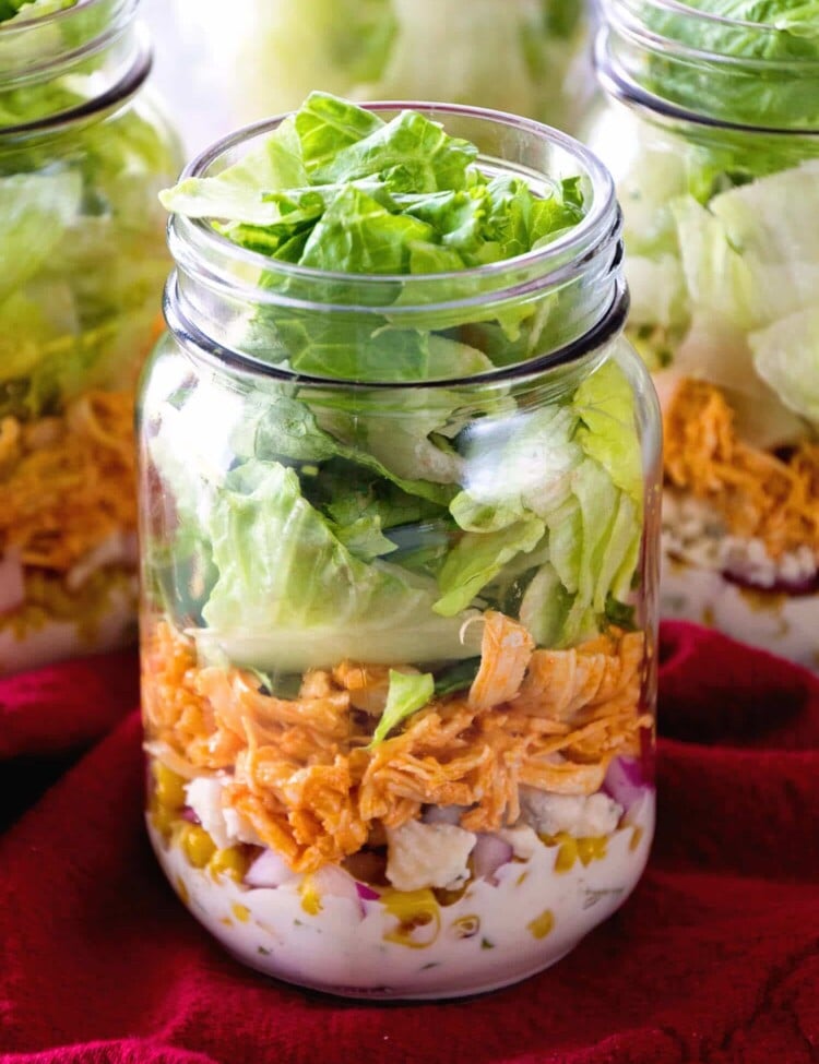 Buffalo Chicken Jar Salad ~ Easy, Light and Healthy Lunch Full of Flavor! Layers of Blue Cheese Dressing, Celery, Blue Cheese Crumbles, Corn, Onions, Buffalo Chicken and Lettuce!