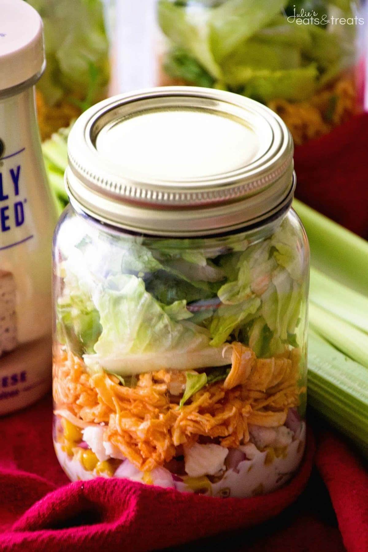 Buffalo Chicken Jar Salad ~ Easy, Light and Healthy Lunch Full of Flavor! Layers of Blue Cheese Dressing, Celery, Blue Cheese Crumbles, Corn, Onions, Buffalo Chicken and Lettuce!