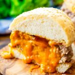 Juicy lucy burger cut in half on a cutting board