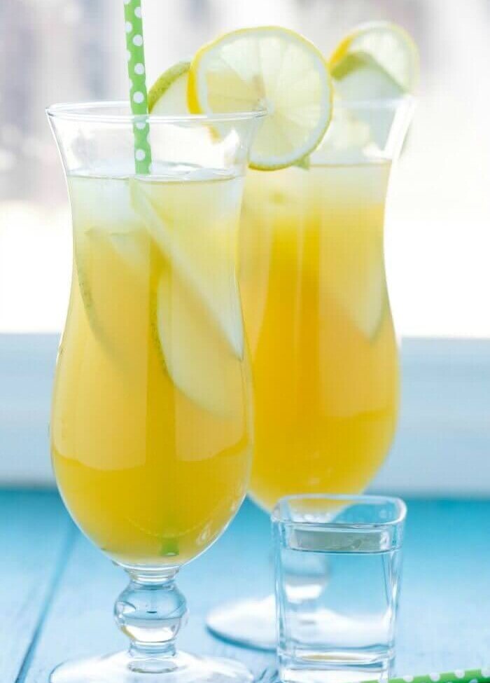 Pineapple Fruit Cocktail Drink Recipe ~ A blend of pineapple, apple, and orange juice are the stars of the show with this pineapple fruit cocktail. Served with sliced pear and the optional rum which are also refreshing for the summer!