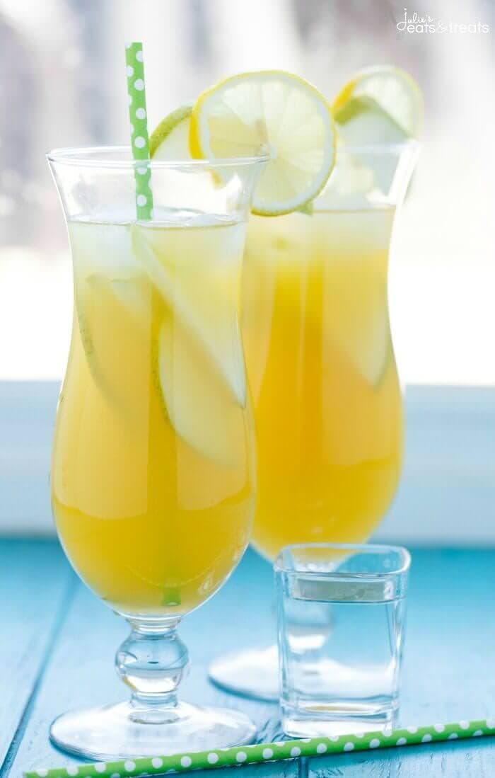 Pineapple Fruit Cocktail Drink Recipe ~ A blend of pineapple, apple, and orange juice are the stars of the show with this pineapple fruit cocktail. Served with sliced pear and the optional rum which are also refreshing for the summer!