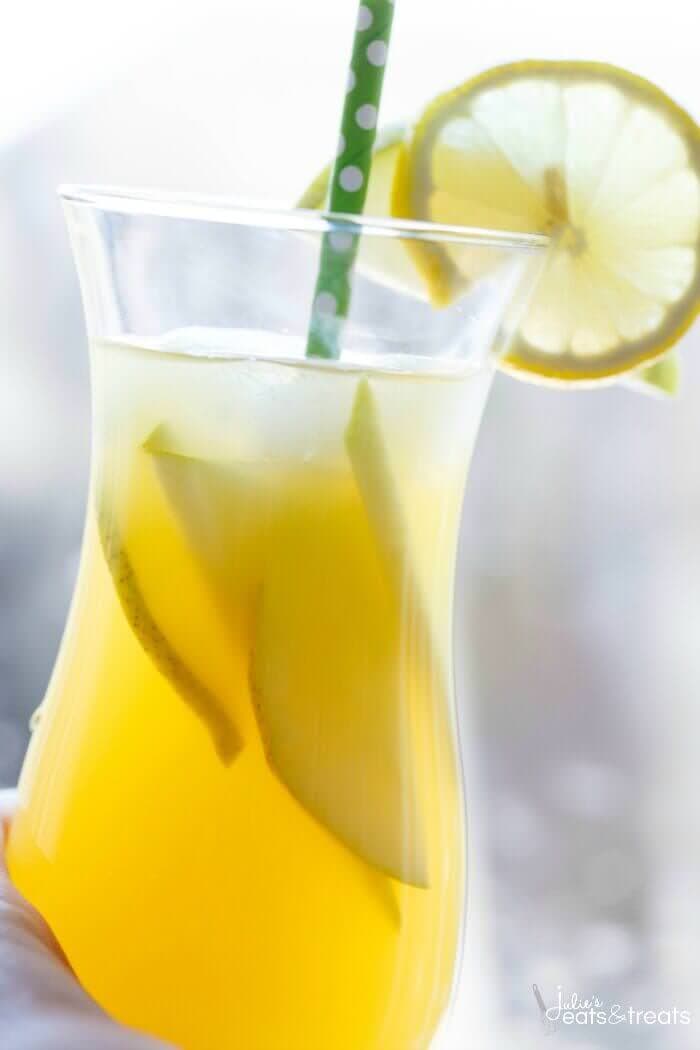 Pineapple Fruit Cocktail Drink Recipe ~ A blend of pineapple, apple, and orange juice are the stars of the show with this pineapple fruit cocktail. Served with sliced pear and the optional rum which are also refreshing for the summer!