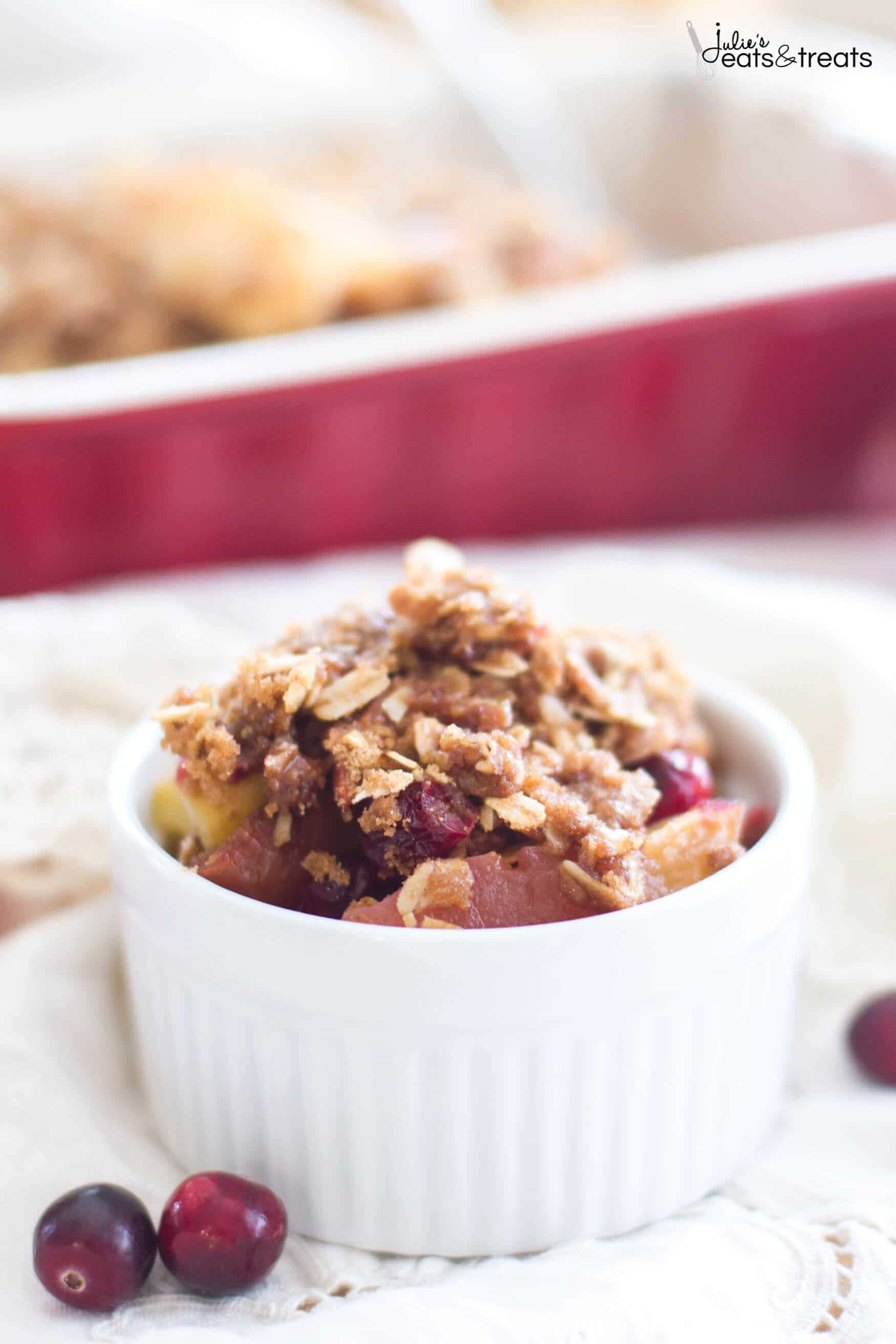 A white bowl filled with Apple Cranberry Crisp.