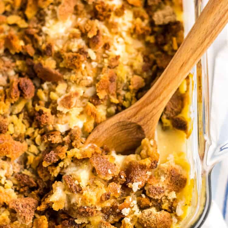 Wooden spoon in a pan of chicken stuffing casserole