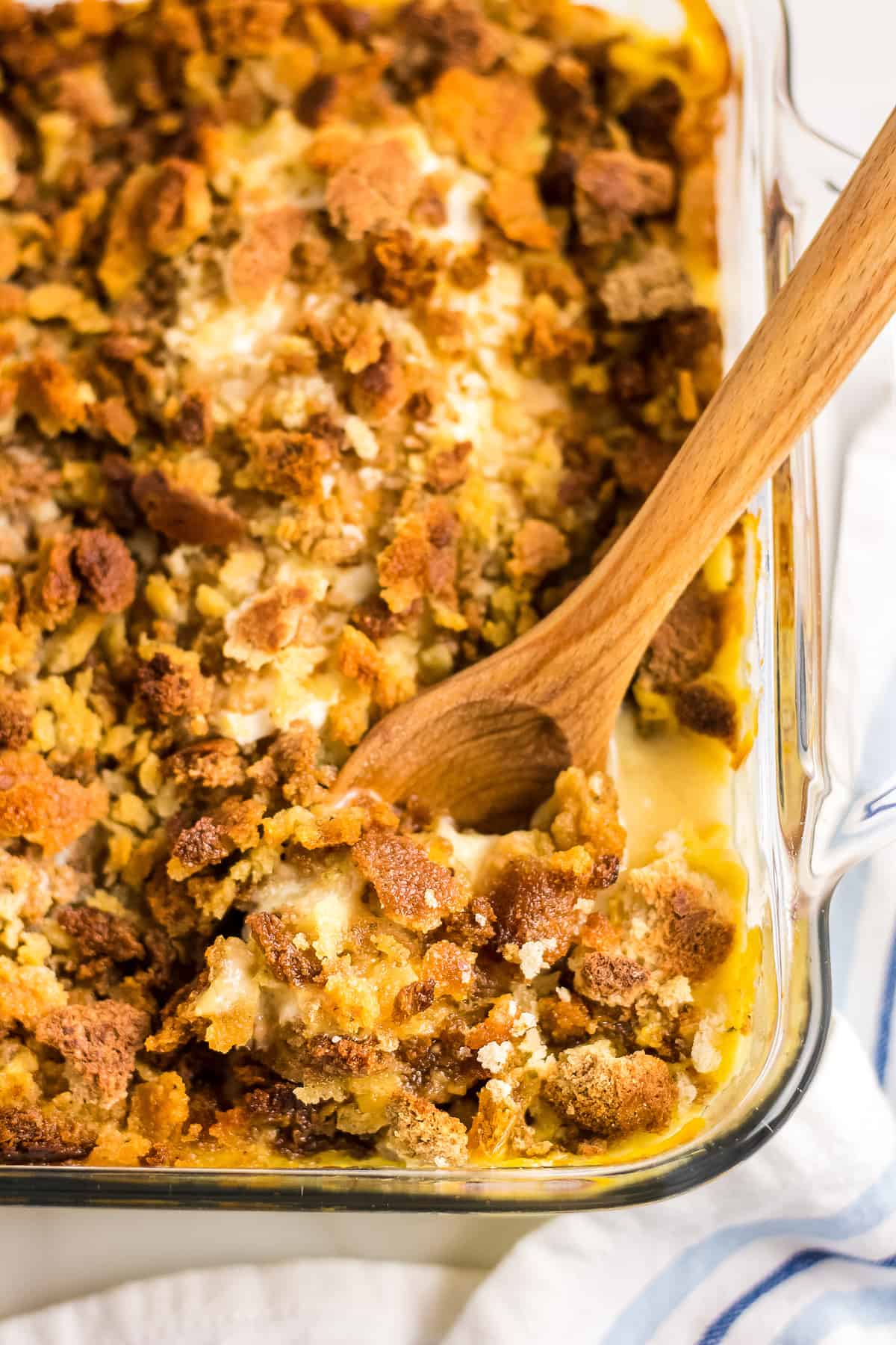 Wooden spoon in a pan of chicken stuffing casserole