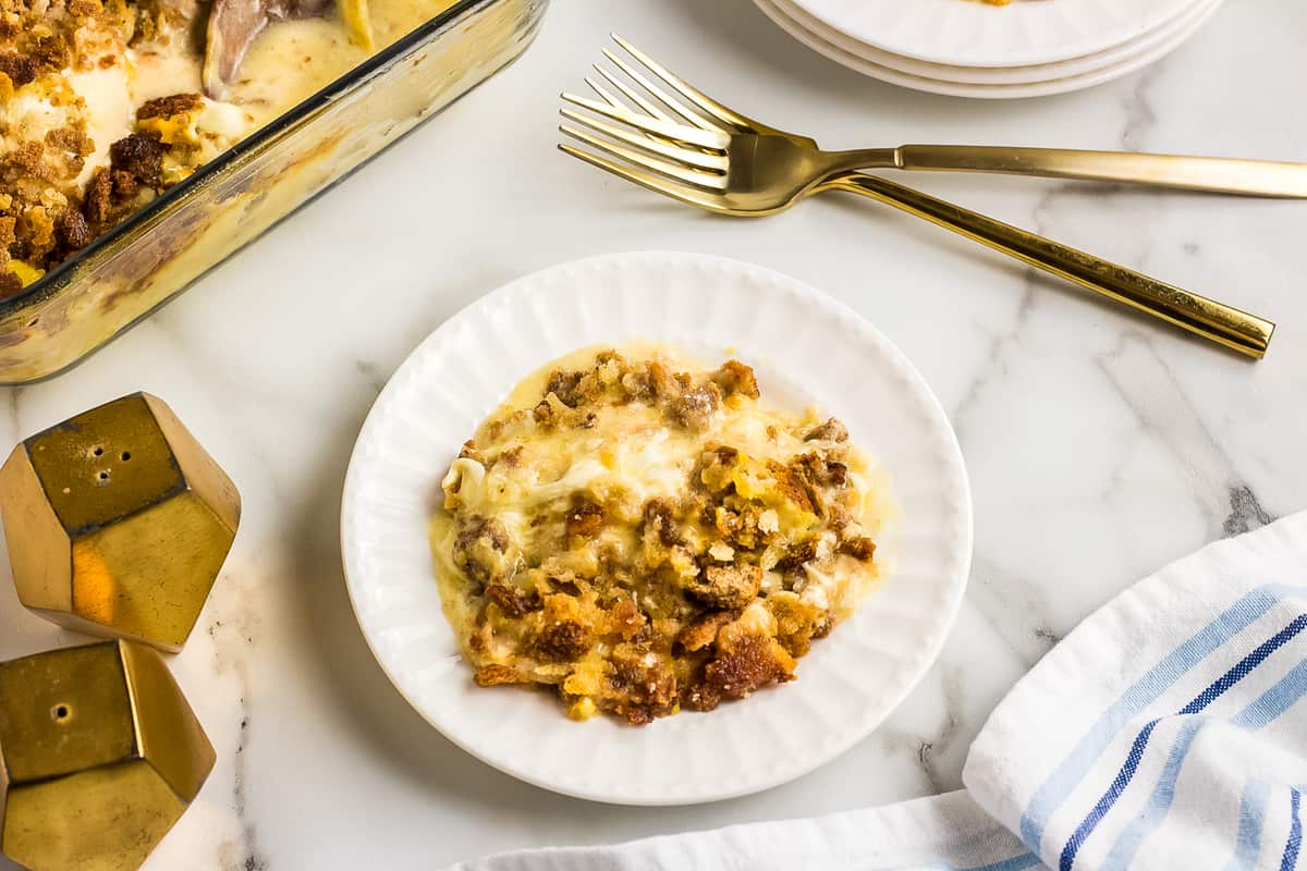 A white plate with chicken stuffing casserole on it