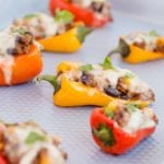 Sweet pepper poppers on a metal baking sheet