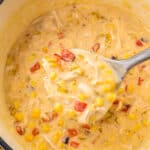 Metal ladle scooping Turkey Corn Chowder out of stock pot