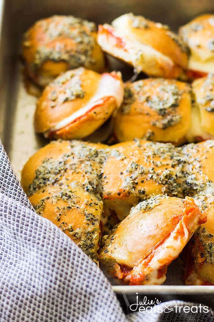 A pan of pepperoni pizza sliders brushed with a buttery topping.