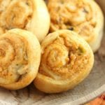 Four crescent chicken taco pinwheels in a wood bowl