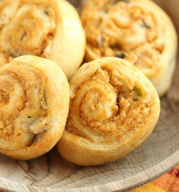 Four crescent chicken taco pinwheels in a wood bowl