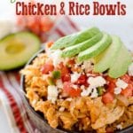 Light crock pot fiesta chicken and rice in a bowl topped with tomatoes and avocado slices
