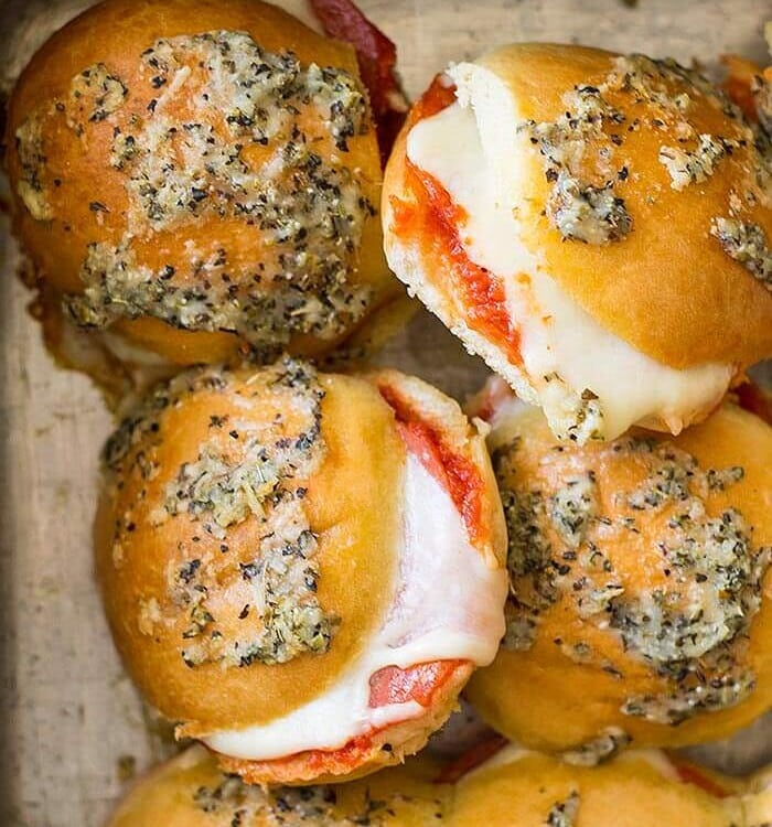 A cake pan full of pizza slider sandwiches
