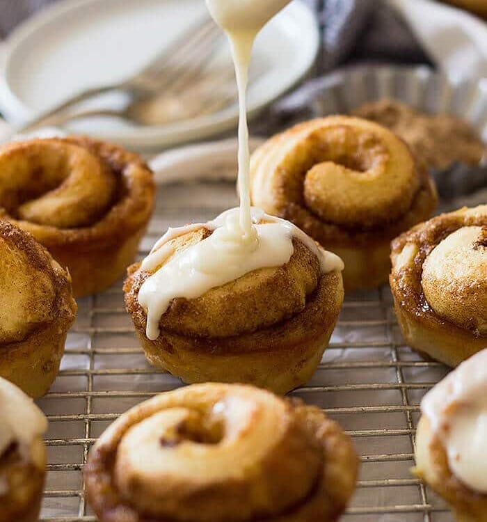 These Cinnamon Roll Muffins are filled with cinnamon and sugar then drizzled with a vanilla icing!