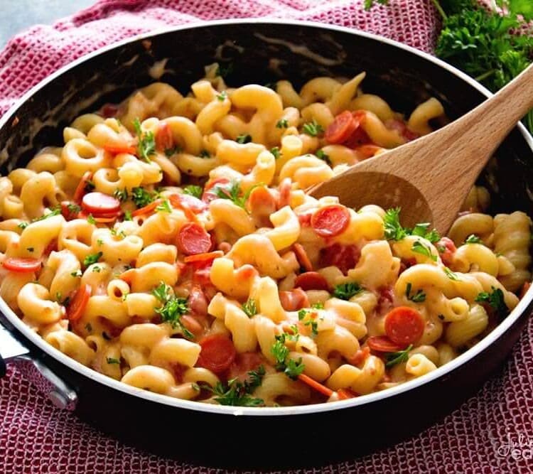 One pot cheesy pizza pasta in a black skillet pan on a red towel