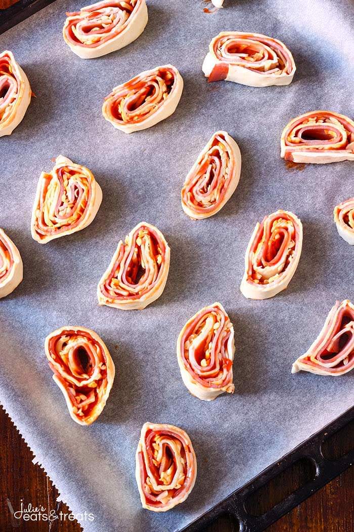 Puff Pastry Appetizers on a baking sheet lined with parchment paper, ready to go into the oven.