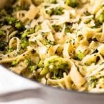 Roasted broccoli alfredo in a white skillet pan
