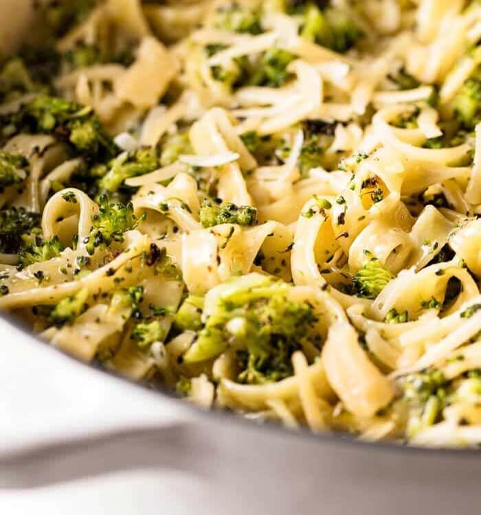 Roasted broccoli alfredo in a white skillet pan