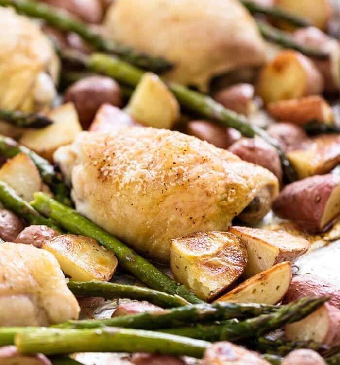 Simple chicken and vegetables on a sheet pan including asparagus and potatoes