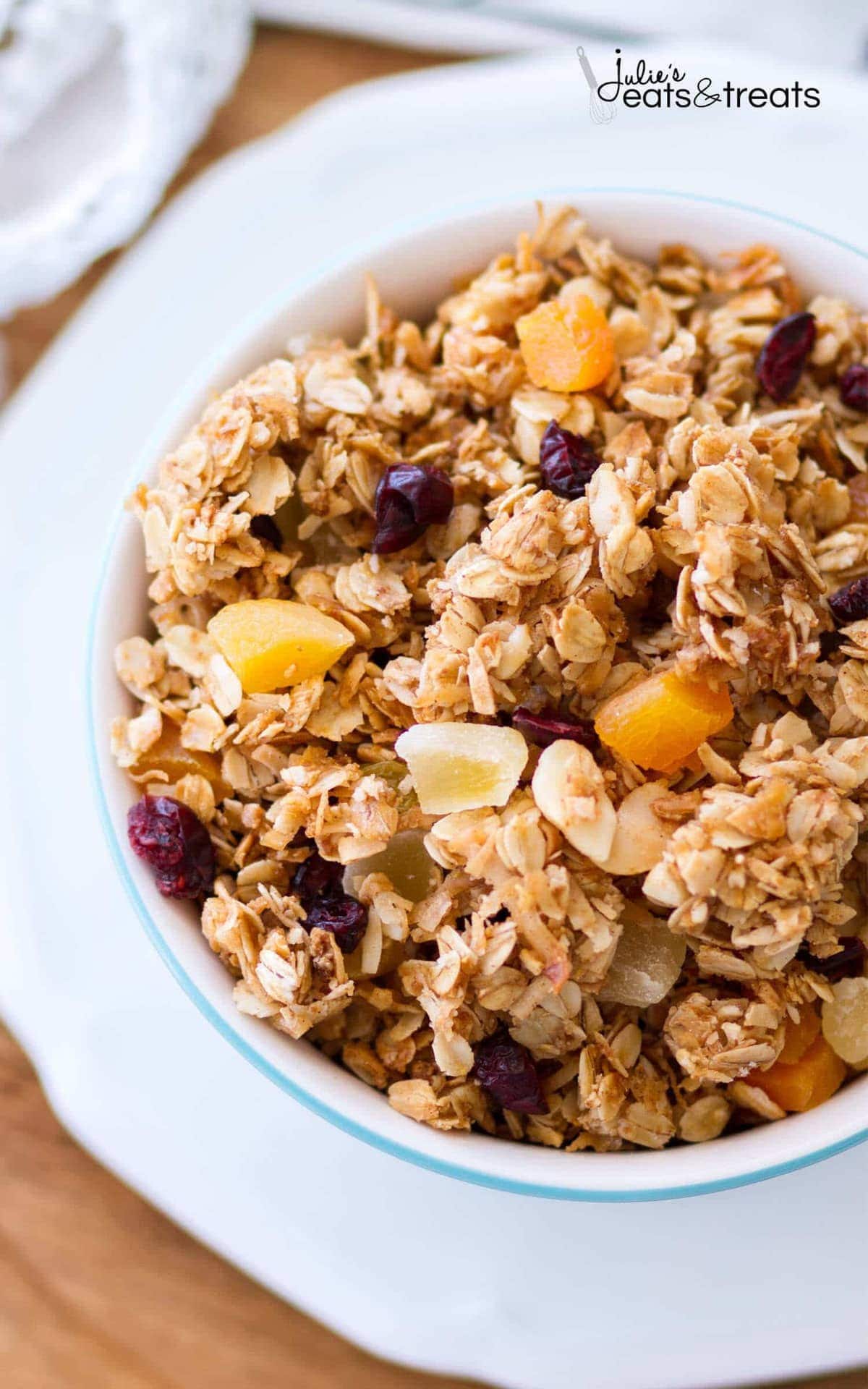 This homemade Tropical Coconut Granola is filled with shredded coconut, coconut oil, and coconut sugar! Dried pineapple, apricots, golden raisins, cranberries, and macadamia nuts give this easy coconut granola a tropical flavor. This homemade granola recipe is so easy, you may never buy store-bought again!