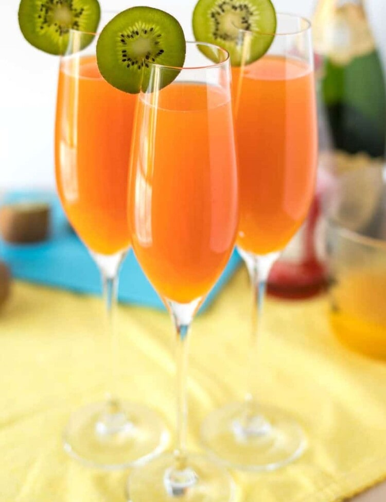 Tropical Mimosas - The classic brunch drink, given a tropical twist with the addition of mango, pineapple, and a splash of grenadine.