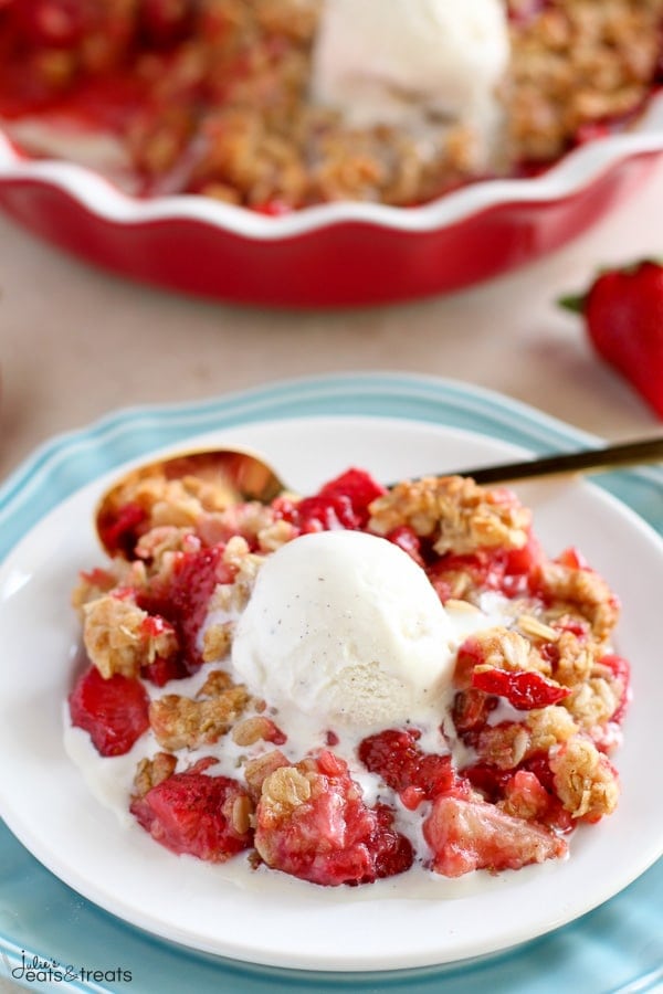 Strawberry Crisp on white plate with ice cream