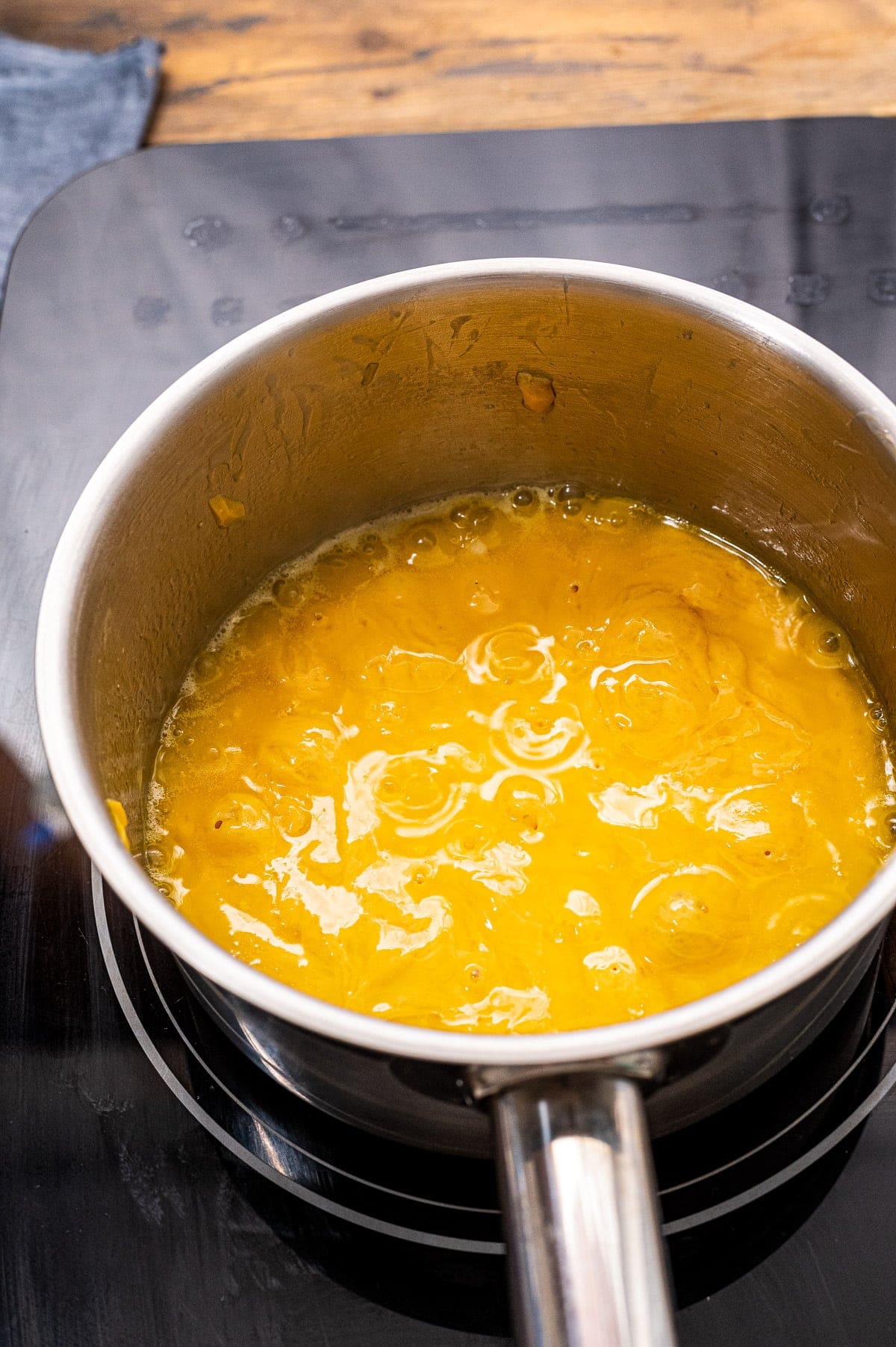 Saucepan with a homemade cheese sauce in ti bubbling