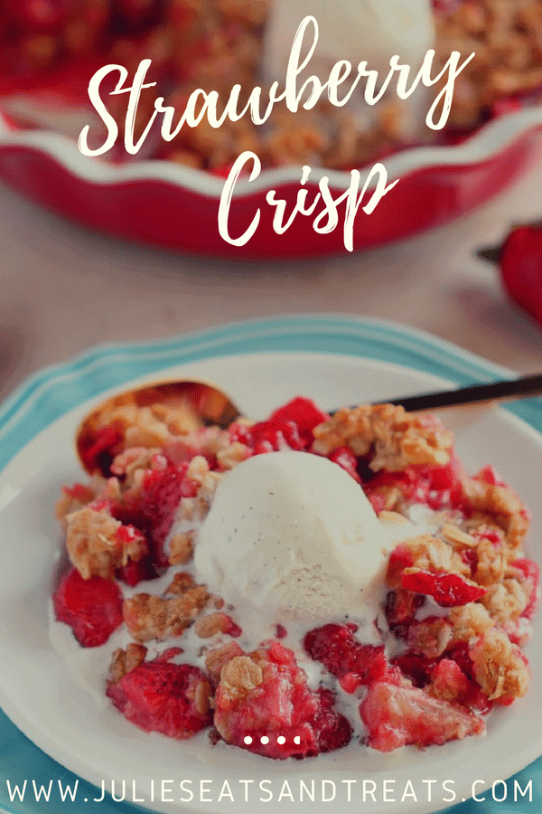 Easy strawberry crisp topped with ice cream on a white plate