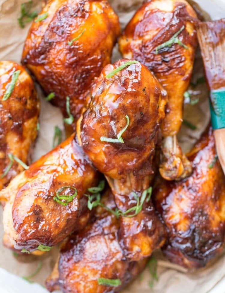 Baked Barbecue Chicken Drumsticks in a white dish