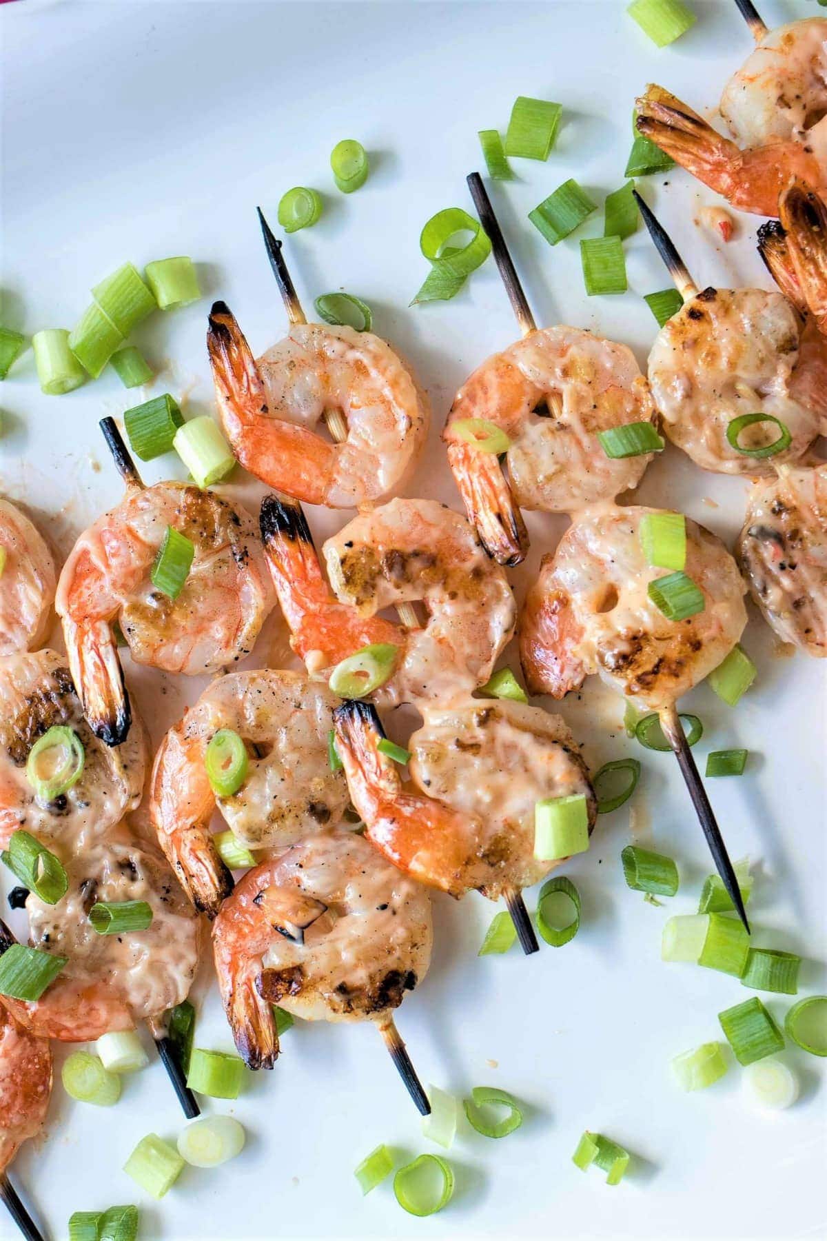 Grilled Bang Bang Shrimp Skewers - Grilled shrimp skewers covered in a spicy, creamy, sweet chili sauce. Perfect for the summer barbecues!
