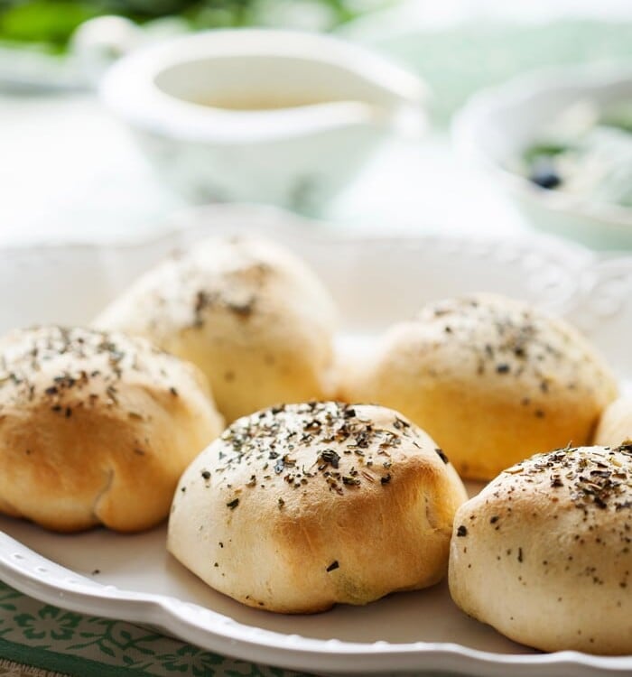 Five chicken pesto pillows on a white plate