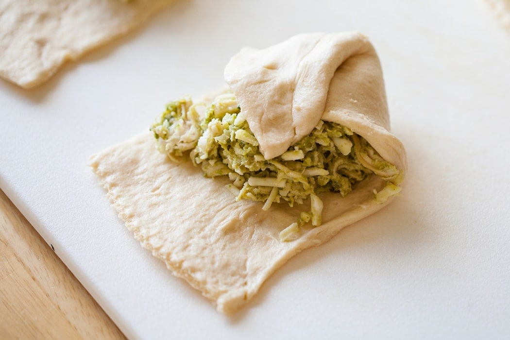Pesto Chicken Pillows are chicken, pesto and cheese wrapped up in a soft croissant. Only 4 Ingredients and 30 Minutes until Dinner is Served!