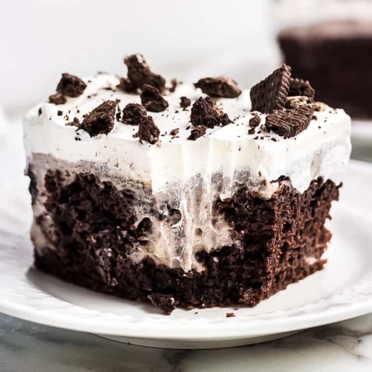 White plate with a piece of oreo poke cake